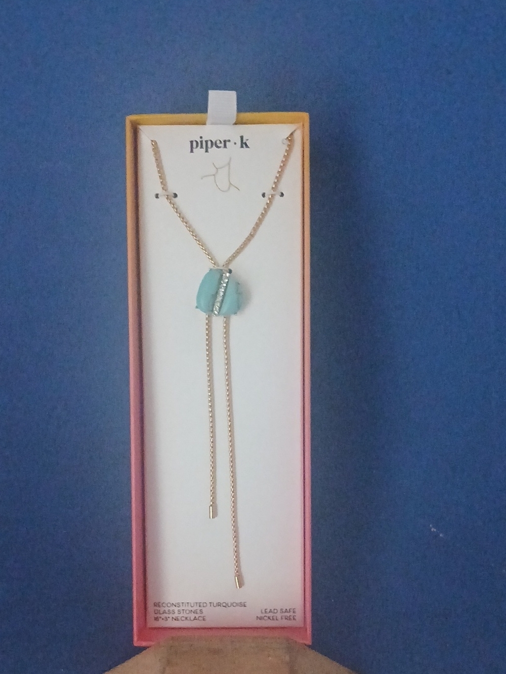 Piper K Gold Lariat Necklace with Turquoise-Colored Pendant.